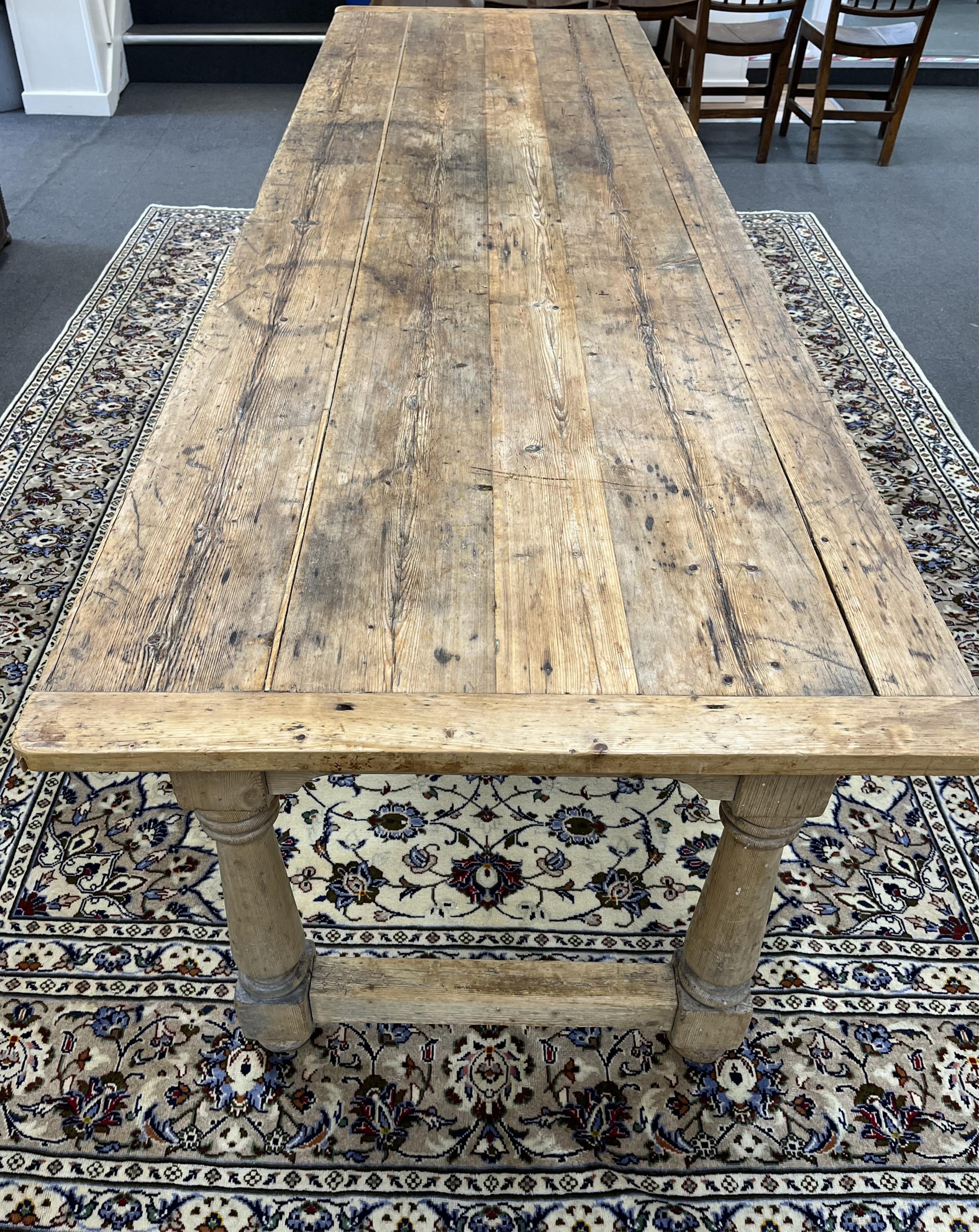An 18th century style rectangular pine refectory dining table, width 283cm, depth 88cm, height 76cm. Condition - fair